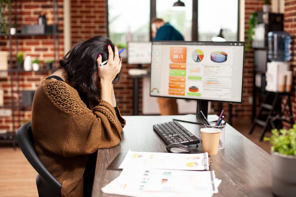woman resting her head office desk