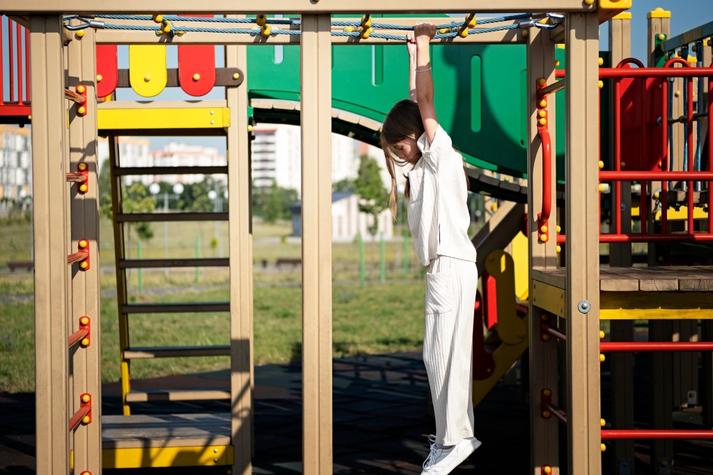 young kid having fun outdoors playground